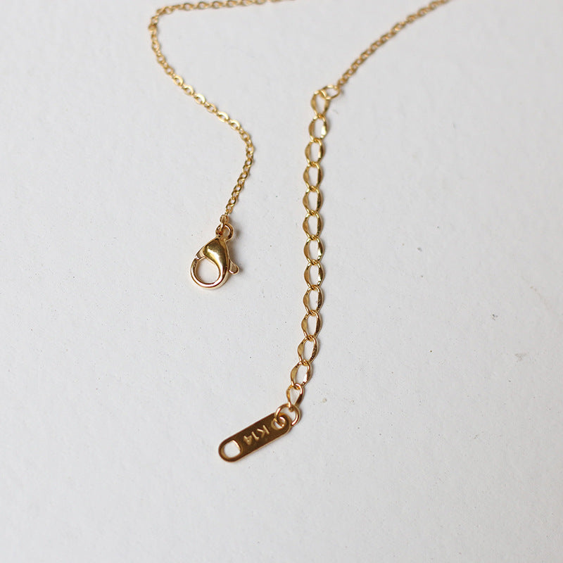 Nelly – Minimalistische Kreuzhalskette in Gold